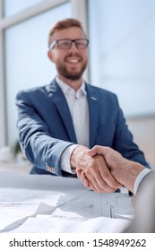 Close Up. Business Handshake Over The Desk