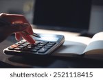 Close up, business woman working at office, using calculator to calculate company finance, accounting with laptop computer on table, budget management. Doing finance, budgeting and tax calculation