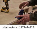 Close up. Carpenter work in the workshop. Woodwork and furniture making concept. Carpenter in the workshop marks out and assembles parts of the furniture cabinet
