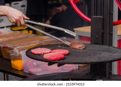 Close Up: Chef Grilling Fresh Meat Cutlets For Burgers At Summer Local Food Market. Outdoor Cooking, Barbecue, Cookery, Gastronomy And Street Food Concept