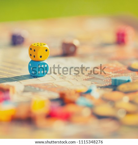Close up: dices at the table with Board game. Gameplay moments. Random game concept, toned photo