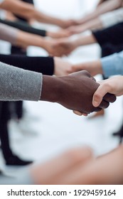 Close Up. Diverse Young People Shaking Hands With Each Other.