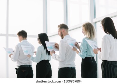 close up. employees with financial reports, standing in line. - Powered by Shutterstock