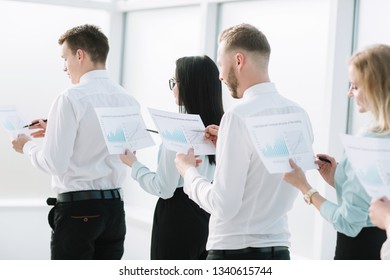 close up. employees with financial reports standing in line - Powered by Shutterstock