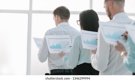 close up. employees with financial reports, standing in line. - Powered by Shutterstock