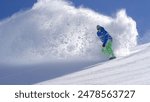 CLOSE UP: Extreme snowboarder riding powder and doing powder turns, spraying snow in sunny mountain backcountry. Snowboarder having fun snowboarding in fresh snow off piste