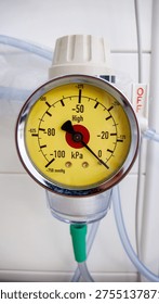 Close up, front view, OFF switch visible
Hospital wall-mounted medical suction vacuum gauge with yellow dial face showing negative pressure scale in kPa and mmHg, with red center indicator and green tubing connector. White OFF switch visible to the right. Vertical composition.