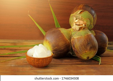 Close up, Group of Sugar palm,Palmyra palm or Toddy Palm. andj peel fruits are in the bolw.Tropical Healthy Refreshment Fruit on wooden talble background and vintage filter.