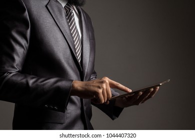 Close Up. Hand Of Businessman In Grey Suit Holding And Touching Application,Checking The Growth Rate Of The Stock Market.on Mobile Phone