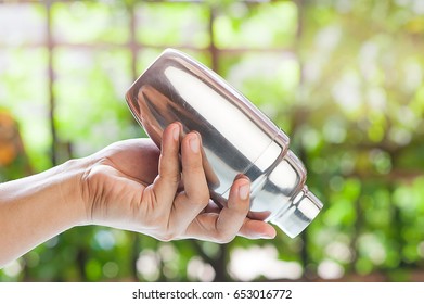 Close Up, Hand Holding Bartender Shaking On Drink In Cocktail Shaker With Bokeh Light Nature Background