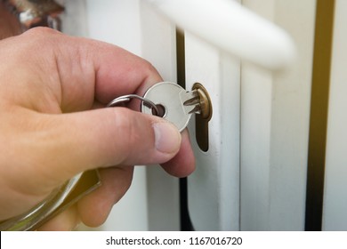Close up. Hand unlocks key lock door. Coming back home.