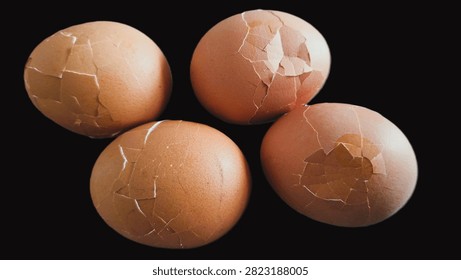 Close up, isolated example of Hardboiled eggs on a surface with the shells rolled and cracked for easy peeling. Close-up of multiple hard-boiled eggs showing the rolling method to crack shells before peeling. Hard-boiled eggs on an isolated background, rolled on a hard surface to crack the shell for easy peeling. Photo of Cooled and gently tapped hardboiled eggs showing the roll and crack technique against a clean background.