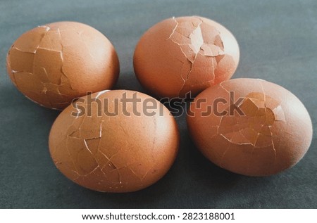 Close up, isolated example of Hardboiled eggs on a surface with the shells rolled and cracked for easy peeling. Close-up of multiple hard-boiled eggs showing the rolling method to crack shells before peeling. Hard-boiled eggs on an isolated background, rolled on a hard surface to crack the shell for easy peeling. Photo of Cooled and gently tapped hardboiled eggs showing the roll and crack technique against a clean background.
