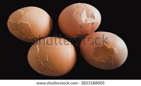 Close up, isolated example of Hardboiled eggs on a surface with the shells rolled and cracked for easy peeling. Close-up of multiple hard-boiled eggs showing the rolling method to crack shells before peeling. Hard-boiled eggs on an isolated background, rolled on a hard surface to crack the shell for easy peeling. Photo of Cooled and gently tapped hardboiled eggs showing the roll and crack technique against a clean background.