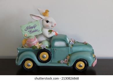 The Close Up, Isolated Image Of The Easter Bunny Driving A Blue Pick Up Truck. He Has A Chick On His Head, Colorful Eggs In The Truck's Bed, And A Sign That Reads 