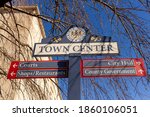 Close up, isolated image of a sign post located in the town center of Rockville, Maryland showing directions of shops, courts and government offices. Rockville is the county seat of Montgomery County.