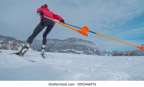 CLOSE UP, LOW ANGLE, DOF: Cinematic Shot Of Unrecognizable Female Athlete During Intense Ski Training In The Slovenian Mountains.