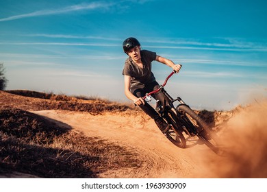 Close up, low angle view of mountain biker on a dusty road