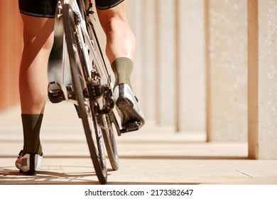 Close Up, Low Angle View On A Bike, Back Wheel On Foreground. Man's Legs Riding His Bicycle On Road In Summer. Concept Of Extreme Cycling