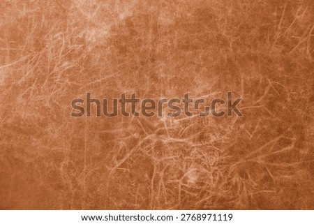 Close up, macro of matte orange genuine leather, leatherette surface with fine grain and soft fibrous texture. Smooth faux leather, upholstery material, abstract background, wallpaper, backdrop