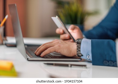 Close Up. Male Businessman Work With Phone And Laptop In The Office.