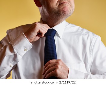 Close Up, Male Wearing White Shirt And Blue Tie, He Loosen The Tie Knot, Yellow Background