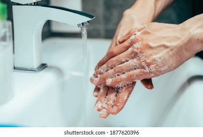 close up. modern guy carefully lathering his hands . - Shutterstock ID 1877620396