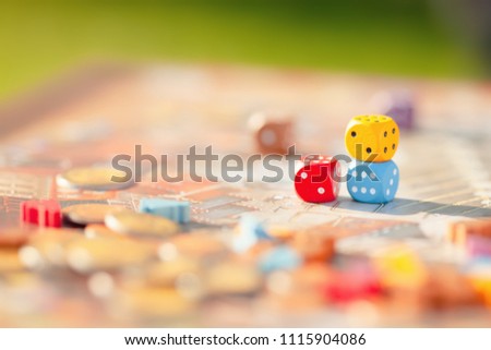Close up: multicolored dices at the table with Board game. Gameplay moments.  Toned photo