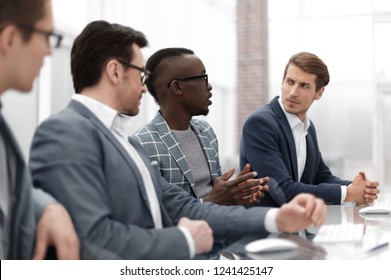 close up. multinational business team sitting at the Desk - Shutterstock ID 1241425147
