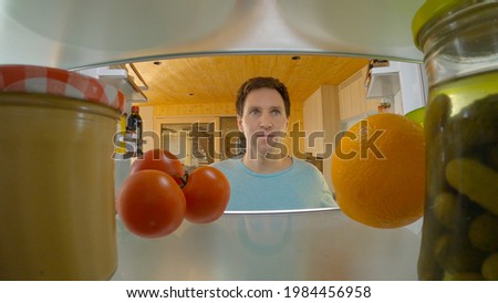 Similar – A hungry woman looks in the fridge