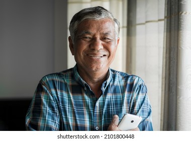 Close Up, Portrait Of Older Man Smiling And Looking At The Camera In The Room At Home.