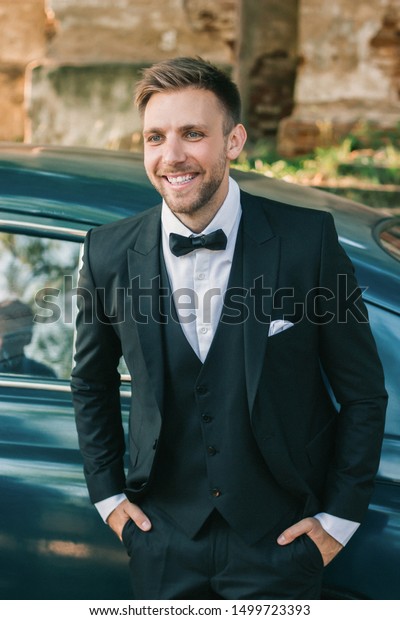 close
up. the proud groom standing near the car the
car