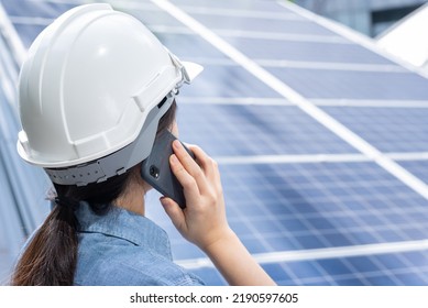 Close Up, Rear View Portrait With Copy Space Of Unrecognizable Female Professional Asian Woman In White Safety Hardhat, Holding Mobile Phone, Making A Call. Engineer, Foreperson, Solar Panel Concept.