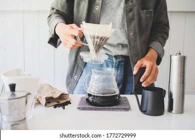 Close up. roasted coffee on coffee percolator with professional of a barista making coffee for dripping hot coffee into the cup with equipment, tool brewing at kitchen home