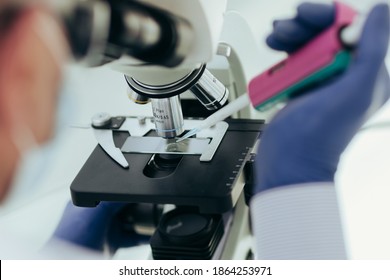 close up. scientist using a microscope in the laboratory.