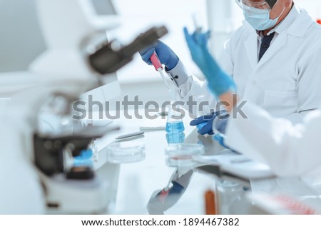 close up. scientists examining liquid samples in the lab.