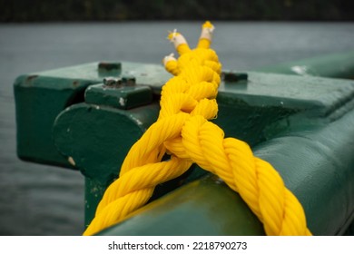 Close Up, Selective Focus On A Yellow, Knotted Rope On The Green Railing Of A Washington State Ferry