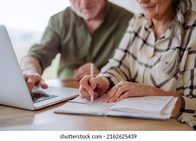 Close up, senior couple calculate expenses or planning budget together at home. - Powered by Shutterstock