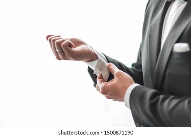 Close Up. A Serious Man Adjusting His Cuff Links.