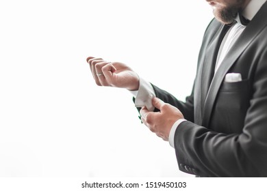 Close Up. A Serious Man Adjusting His Cuff Links.