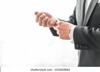 Close Up. A Serious Man Adjusting His Cuff Links.