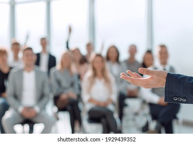 Close Up. Speaker Standing In Front Of The Audience In The Conference Room