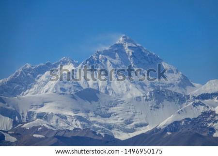 CLOSE UP: Spectacular shot of windswept summit of Mount Everest from scenic Gawula Pass on a sunny day. Strong winds blowing across the Himalayas sweeps the snow off the snow covered mountaintop.