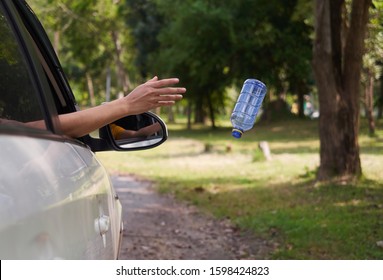 Close Up, Throwing Away Plastic Bottle From Car Window.