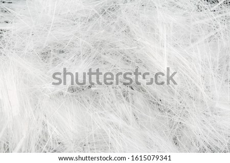 Close up, top down view of monofilament micro polypropylene fiber for concrete structural reinforcement. Construction themed macro background