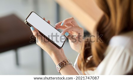 Close up, top view of female with brunette long curly hair using smartphone, scrolling social media feed, smartphone mockup