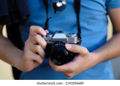 Close up, unrecognizable man with a camera. Selective focus.