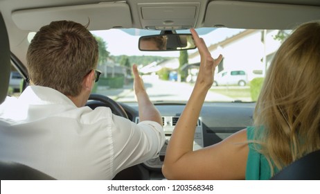 CLOSE UP: Young Couple Argues While Driving Through The Sunny Suburban Area. Caucasian Girlfriend And Boyfriend Screaming And Fighting During Their Summer Road Trip. Tourists Quarreling In The Car.