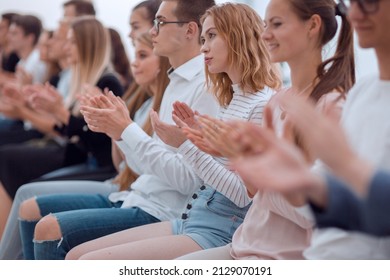 close up. young people sitting in a row applaud. - Shutterstock ID 2129070191