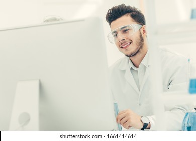 Close Up. Young Scientist Looking At Computer Monitor.